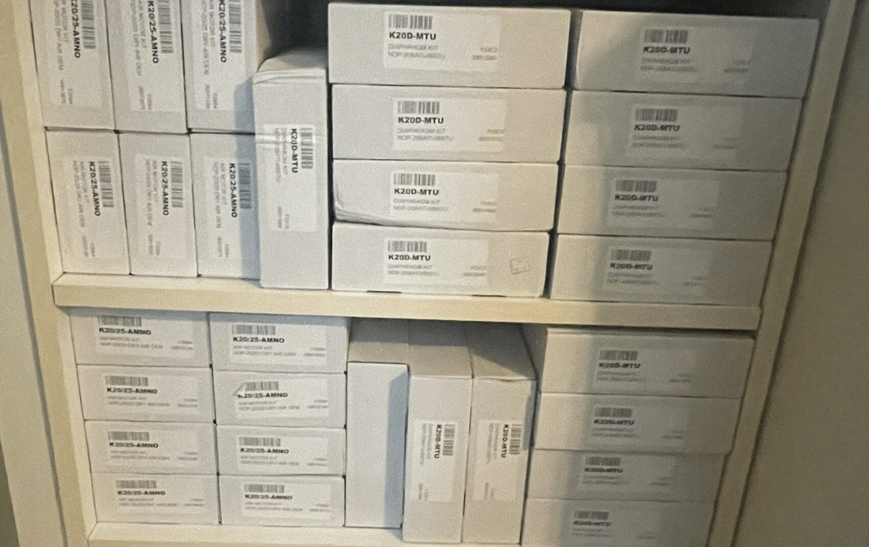 Stacked boxes labeled 'Smartphone' on shelves in a storage area.