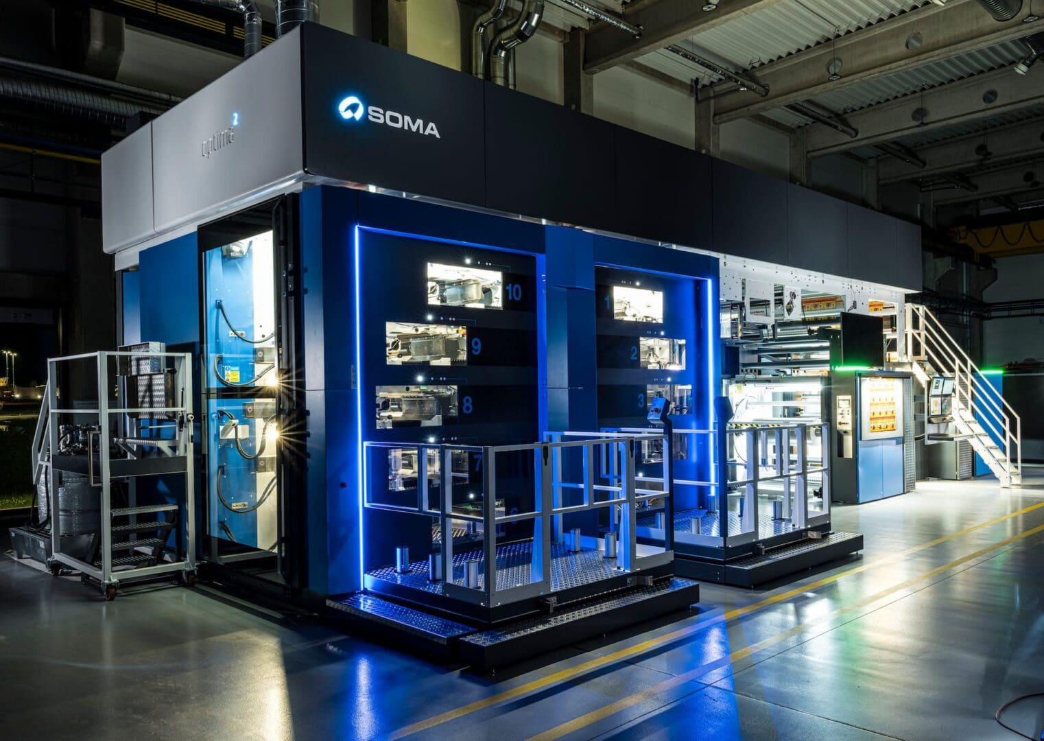 Modern industrial equipment showcased in a sleek, blue-lit display booth.